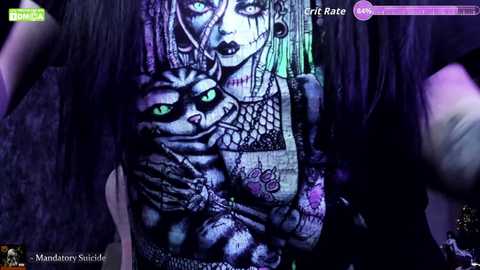 Video of a woman with dark hair, green eyes, and a black and white tattoo featuring a tiger and a skull. She wears a black fishnet top, surrounded by purple and green lighting.