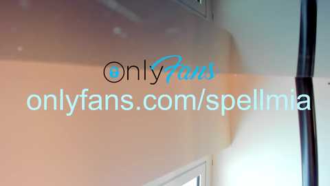 Media: Video of a glossy, light beige wall with OnlyFans.com and OnlyFans.com/sellima overlaid in black and blue text, respectively. The wall features a vertical window with a black frame.