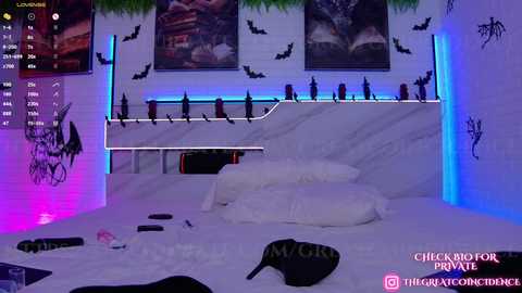 Media: Video of a dimly lit, modern bedroom with white marble headboard, LED lights, bat decorations, and a messy bed with scattered clothes and a black purse.