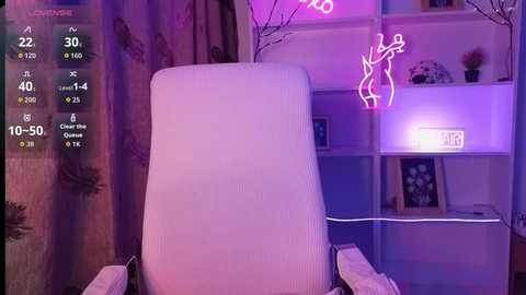 A video of a modern living room with a white armchair, neon pink \"Dancer\" sign, purple ambient lighting, and shelves filled with plants and framed art.
