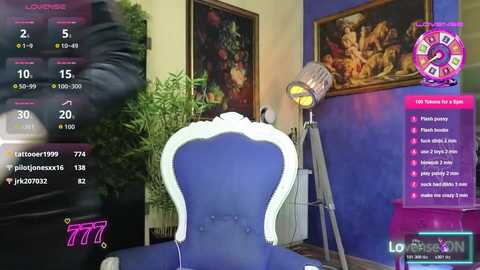 Video of a modern, vibrant room with a blue velvet chair, a large plant, a lamp, and colorful artwork on a blue wall. A virtual camera view is superimposed, showing stats and options on a screen.