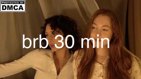 Video of two women, one with curly dark hair, the other with straight red hair, both in beige tops, against a beige curtain background. Text overlay: \"bro 30 min.\
