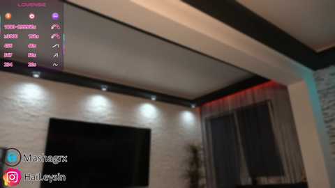 Video of a modern living room with a flat-screen TV, a large window with sheer curtains, and a digital TV guide displaying channels and programming information.