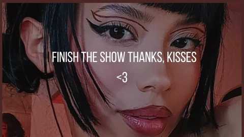 Video of a young Asian woman with straight black hair, sharp eyebrows, and dramatic eyeliner, set against a blurred, warm-toned background. Text above reads \"Finish the show, thanks, kisses,\" with a heart symbol.