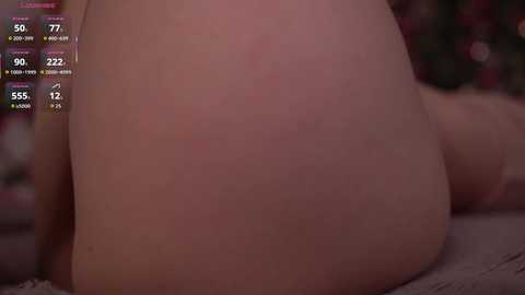 Video of a close-up of a person's bare buttocks, with a digital thermometer display showing 77.7\u00b0F and 12:12 PM in the top left corner. The background is blurred and indistinct.