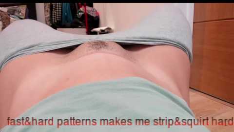 Video of a woman's lower abdomen, showing a strip of light blue panties pulled down to reveal pubic hair. Text overlays read: \"fast&hard patterns makes me strip&squirt hard\".