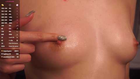 Media: A video of a topless woman with medium-sized, natural breasts, light skin tone, and gray-painted nails pinching her nipple. A chat window with user names and times is visible in the left corner.