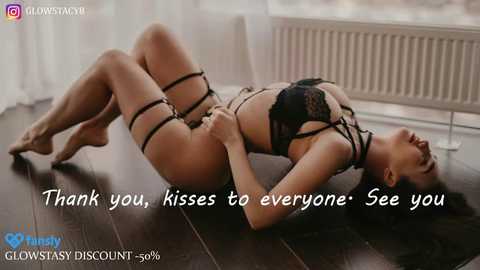 A video of an Asian woman in black lingerie, lying on a dark wooden floor, with text overlay \"Thank you, kisses to everyone. See you.\