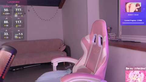 A video of a cozy, dimly lit room featuring a pink gaming chair, a beige couch, and a TV displaying a fitness app screen.